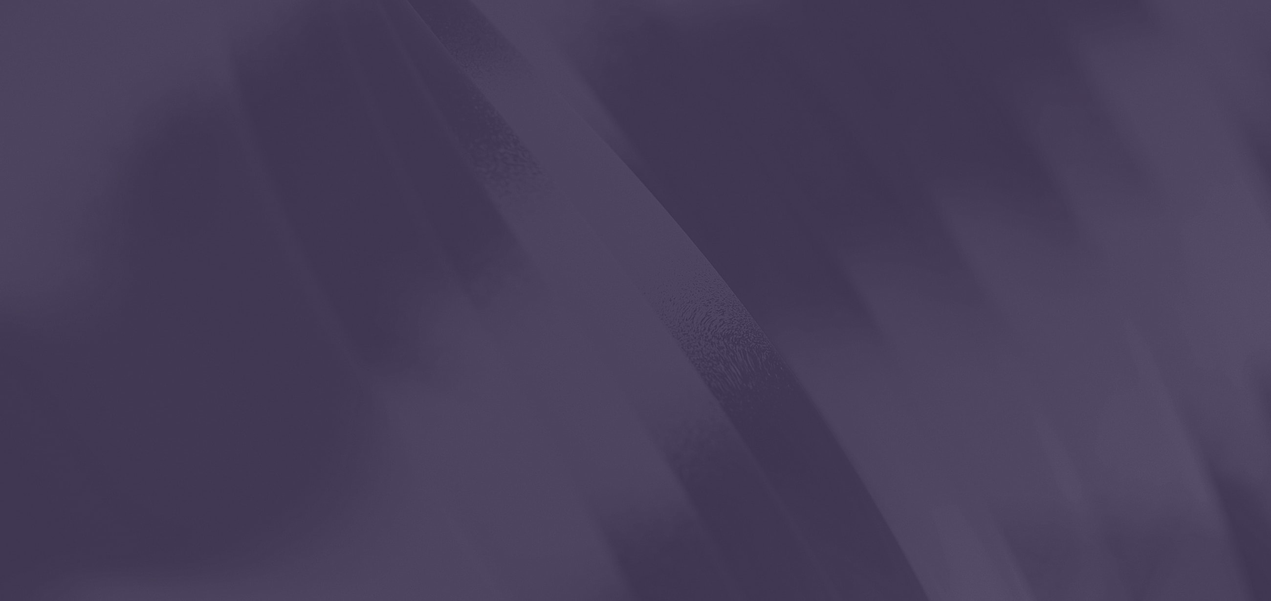 Abstract purple background with smooth gradients.