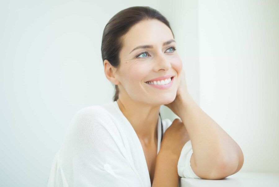 Smiling woman in a light, bright setting.