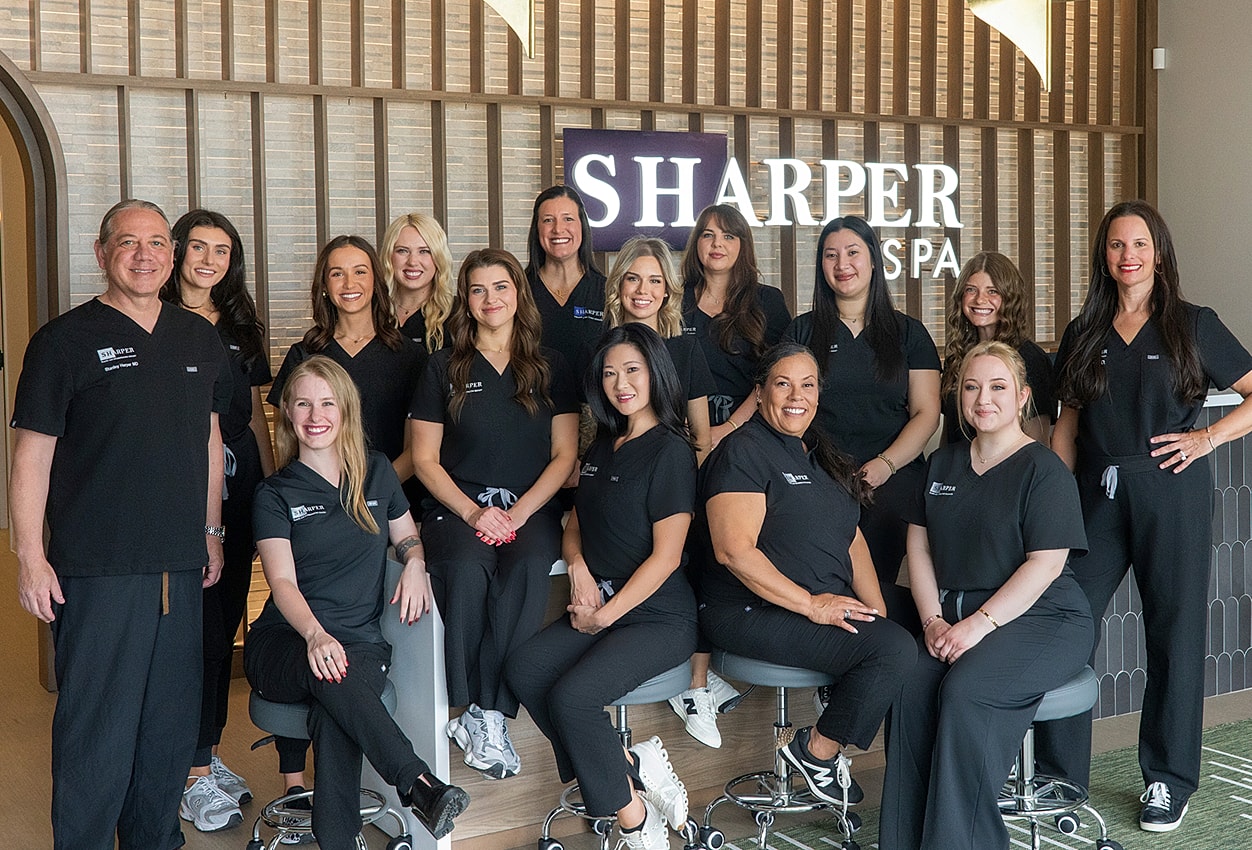Spa team posing in professional attire.