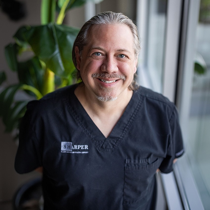 Smiling healthcare professional in a clinic setting.
