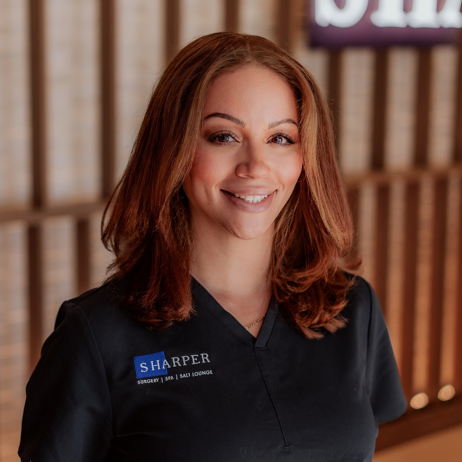 Smiling professional in medical attire.