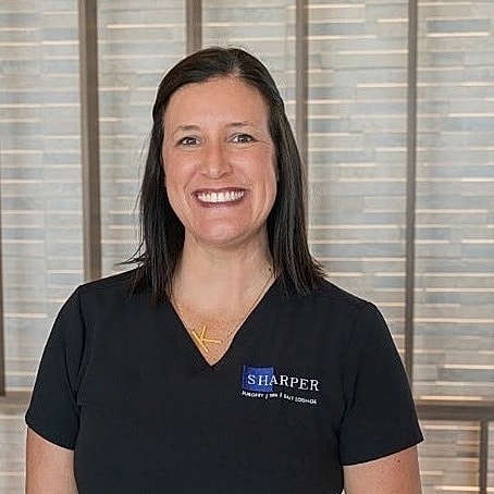 Smiling professional in a healthcare setting.