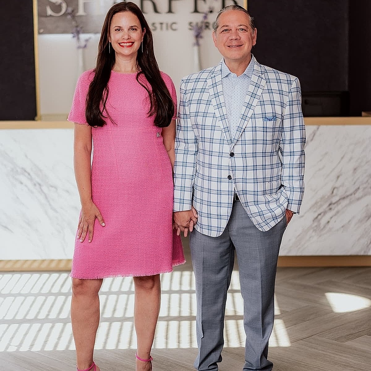 Couple posing at S. Harper plastic surgery office.
