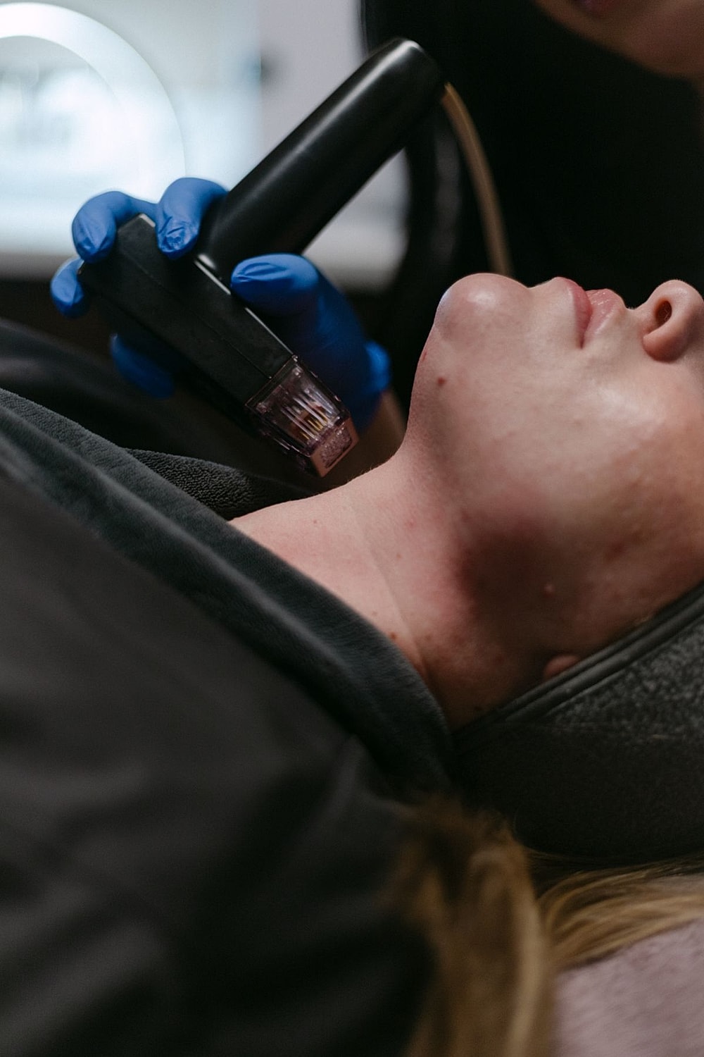 Facial treatment in progress with skincare device.