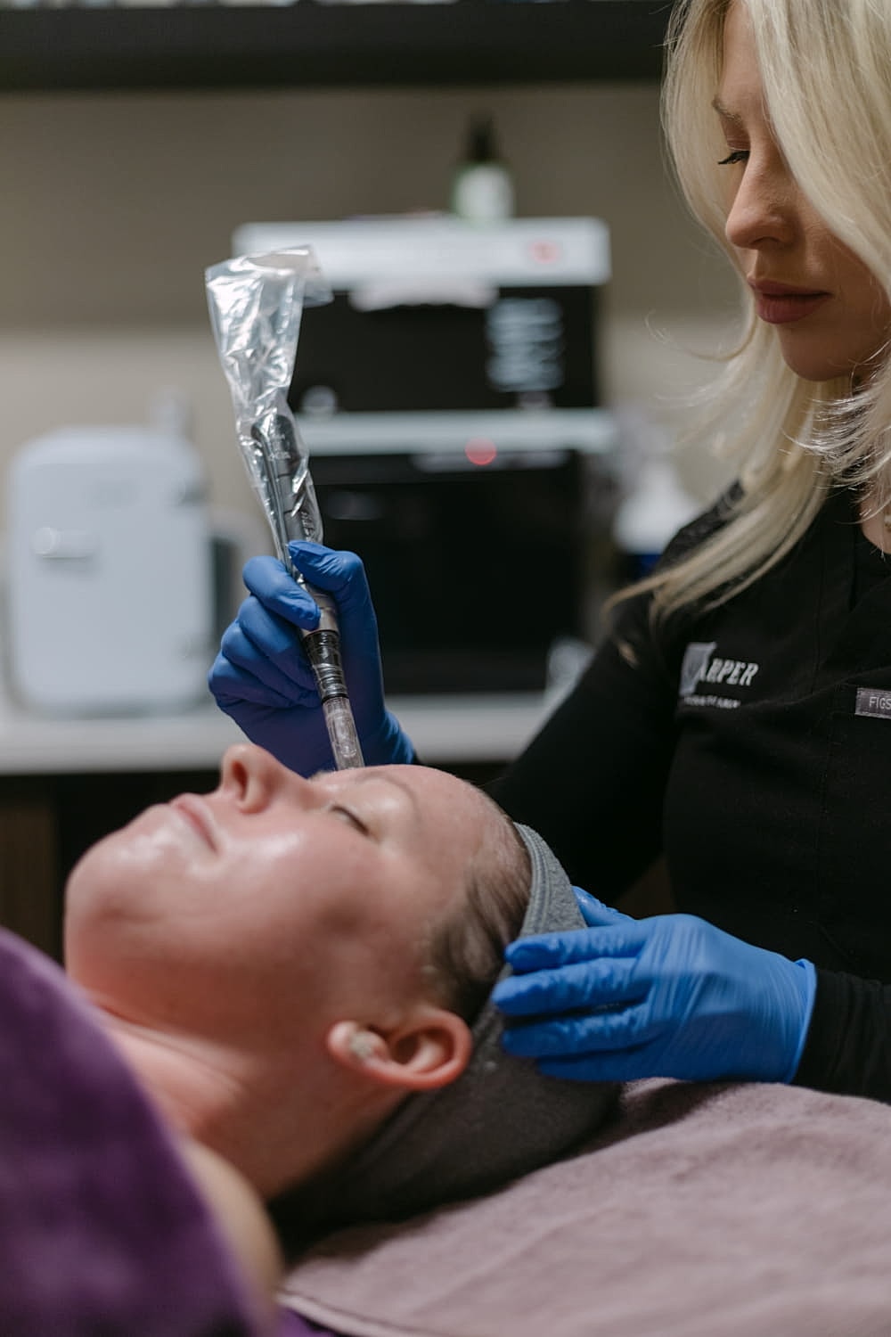Client receiving a facial treatment in clinic.