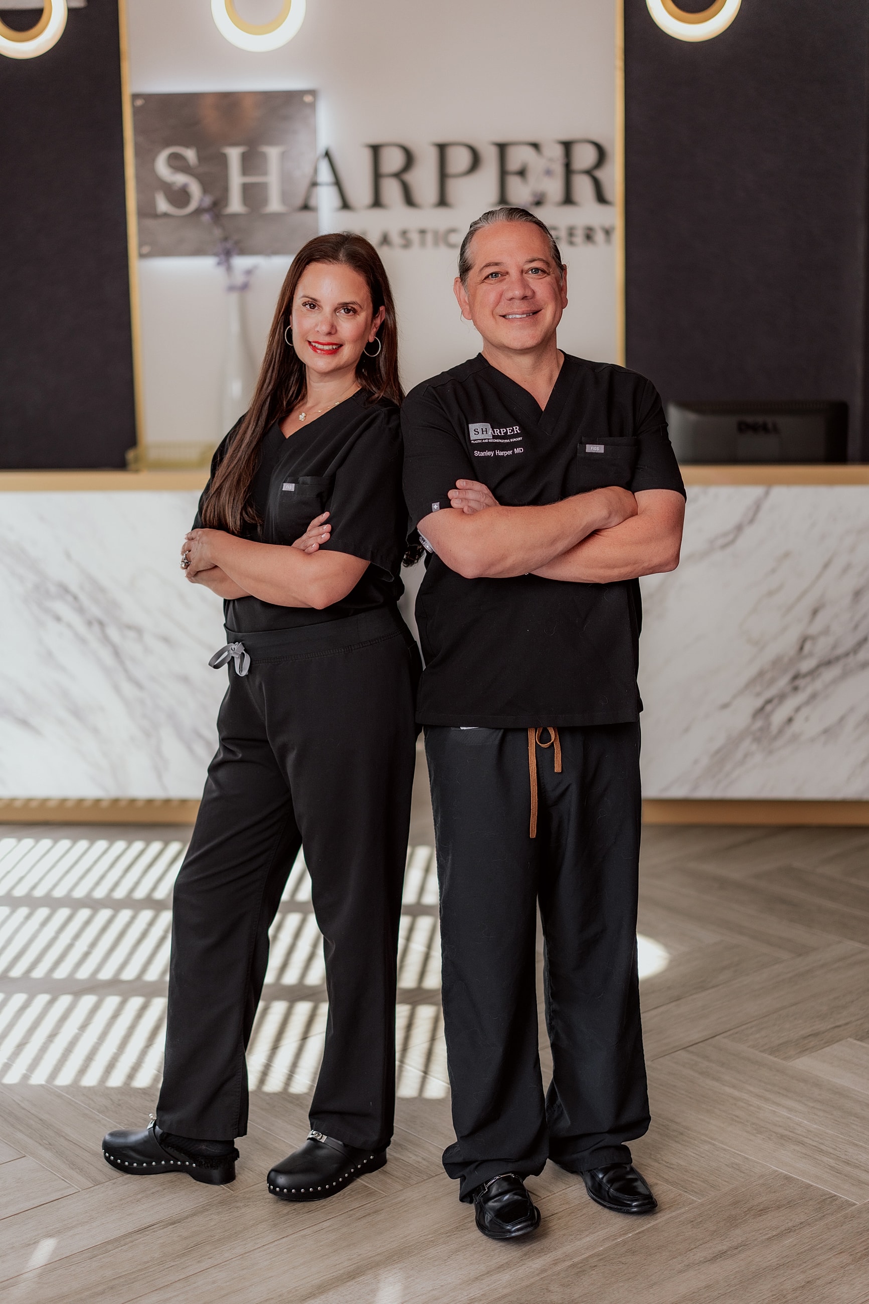 Smiling woman with long, wavy hair.