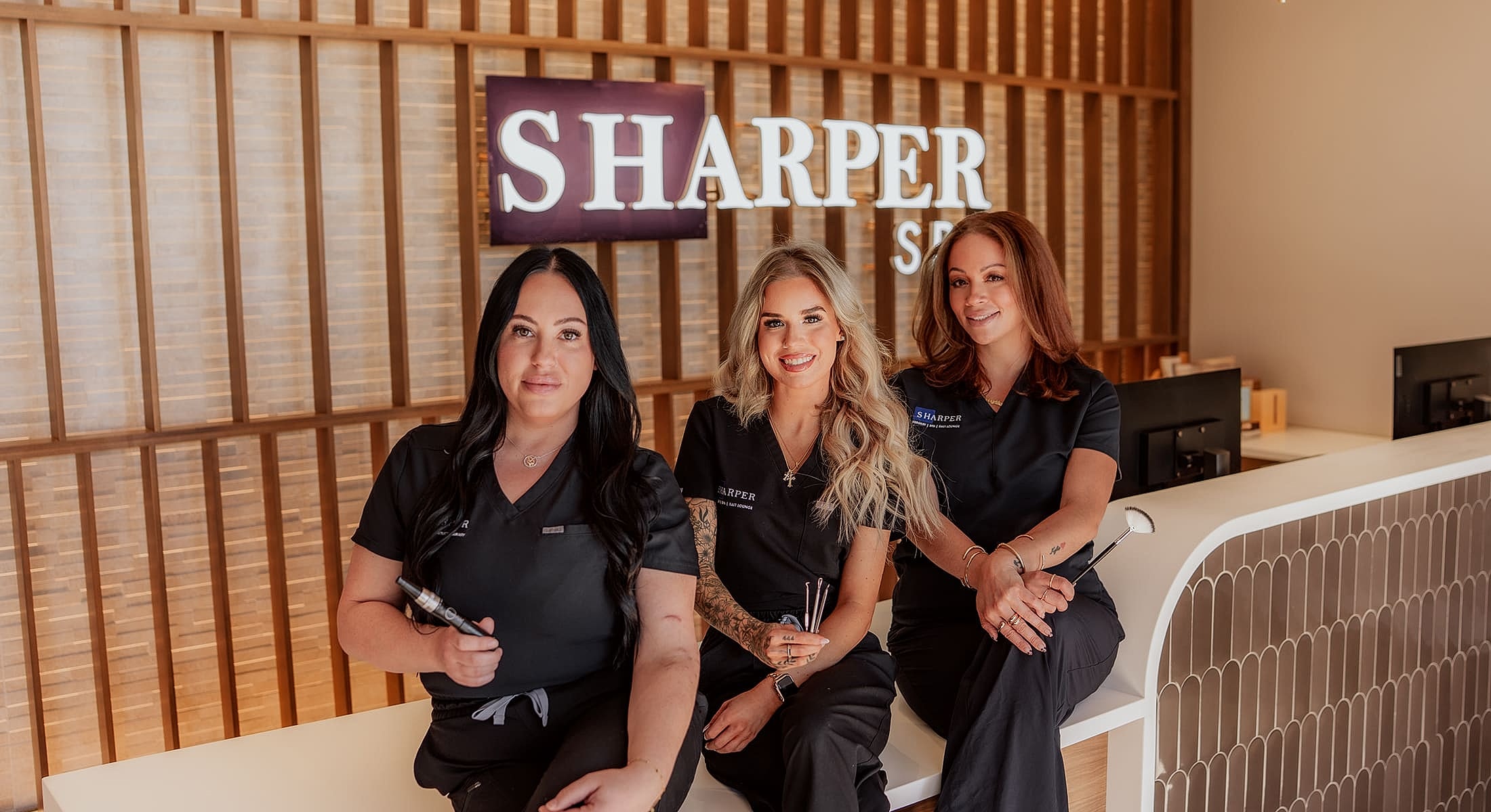 Medical team posing together in matching uniforms.