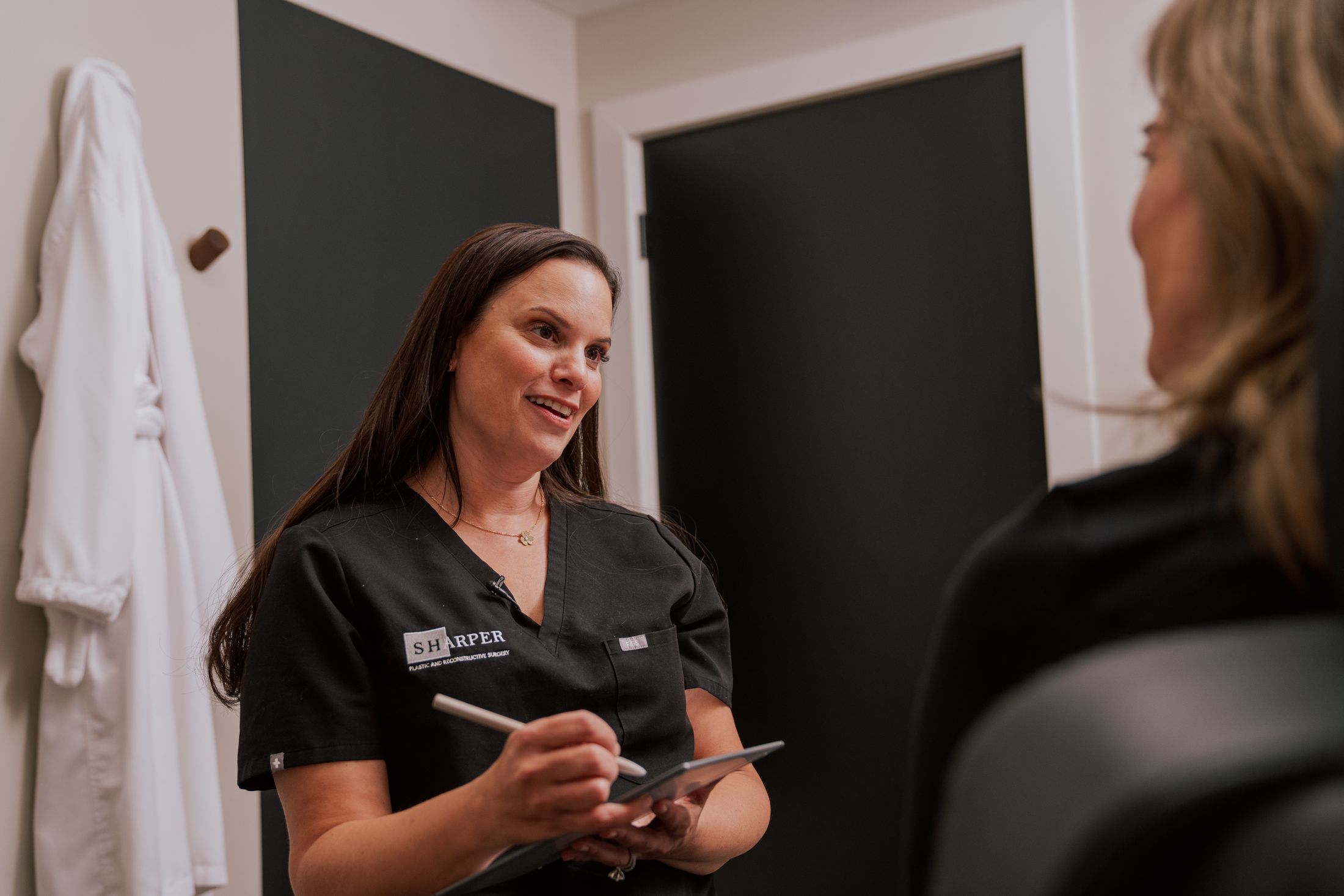 indianapolis jawline fillers staff speaking to patient