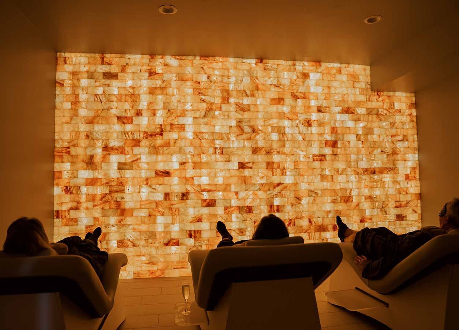 People relaxing in front of the salt wall at salt lounge in Avon